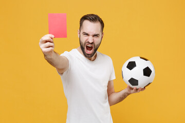 Angry screaming guy football fan in white t-shirt isolated on yellow background. People sport...