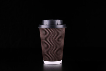 Black background takeaway coffee cup. Coffee to go.