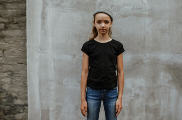 Obraz premium Girl kid wearing black blank t-shirt. Mock up for print.