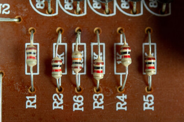 Closeup electronic hardware .Resistor on the white circuit board.