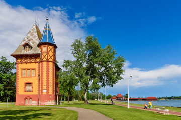 Subotica, Serbia - June 19, 2020. Abandoned Owl tower with tiled rooftop and woodcarving decorative details. Palic castle or Bagolyvar villa on shore of lake is popular landmark.