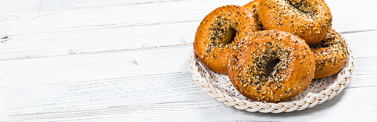 Freshly Baked Bagels Topped with Sesame Seeds, Poppyseeds, Garlic and Onion. Selective focus.