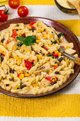 Cheesy Grilled Chicken Alfredo Pasta Florentine with Black Beans and Corn. Selective focus.