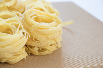 Fettuccine pasta on a beige background. Place for text.