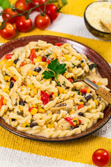 Cheesy Grilled Chicken Alfredo Pasta Florentine with Black Beans and Corn. Selective focus.