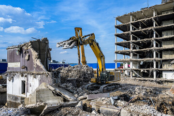 Building House Demolition site Excavator with hydraulic crasher machine and yellow container