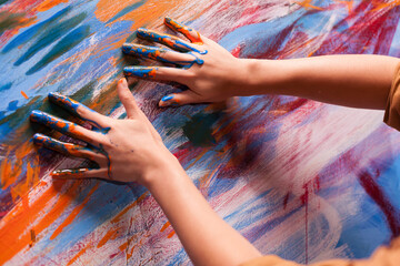 Hands of artist with paint on large canvas in art studio. Modern artwork paint on canvas, creative,...
