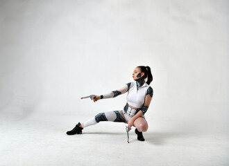 beautiful girl in robot clothes posing with silver revolvers