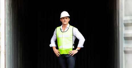 supervisor inspects wearing hardhat safety helmet working and checking control container shipping terminal at  shipping port for import and export