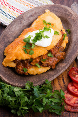 Potato pancakes with meat, vegetable, tomato and parsley