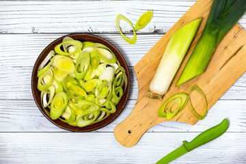 Sliced Leek Green Onion on White Wooden Background. Selective focus.
