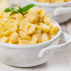 Parmesan Spinach Mac and Cheese on White Wooden Background. Selective focus.