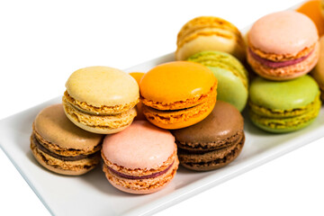 Colorful Macaroons Chocolate, Pistachio, Cherry, Orange, Vanilla Flavor Background Isolated on White Background. Selective focus.