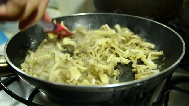 Butter shimeji being prepared in skillet