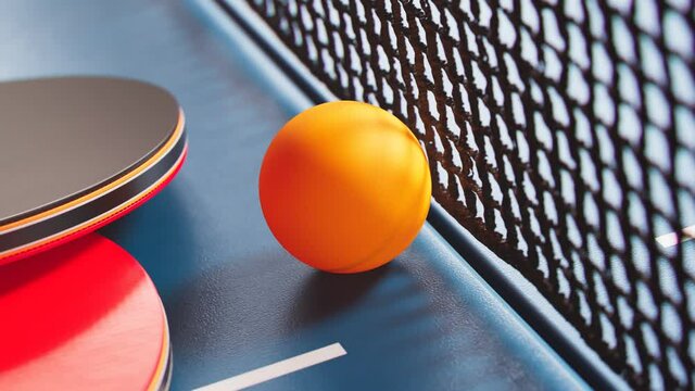 The camera is tilting up a table tennis ball. Ping pong ball, paddles and net.