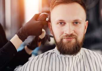 Close up face portrait in barbershop, man with beard 