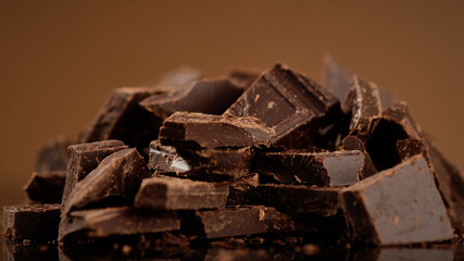 Chunks of sweet dark chocolate, close up, macro shot. Gourmet dessert ingredient
