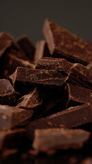 Chunks of sweet dark chocolate, close up, macro shot. Gourmet dessert ingredient