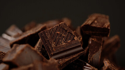 Chunks of sweet dark chocolate, close up, macro shot. Gourmet dessert ingredient