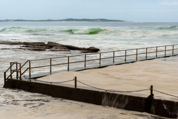 Ocean storm aftermath: A mass of thick foam covered the rock pool following extreme storm weather at Cronulla, NSW, Australia