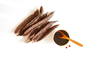 Goat horn and molasses. Photo of molasses on a white background.