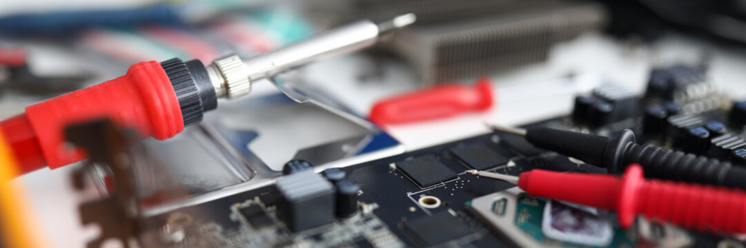 Close up on an electronic device are repair tools