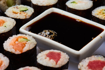Various kinds of sushi roll set served on cutting board. Japanese food