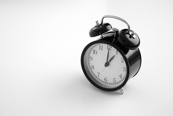 Black vintage alarm clock on table. White background. Wake up concept. An image of a retro clock showing 01:00 pm/am. 