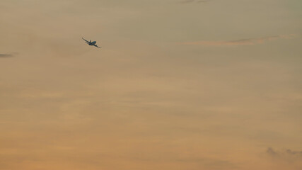 Take-off aircraft against the evening sky after sunset.