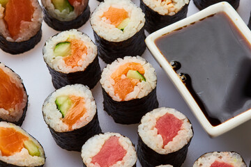 Various kinds of sushi roll set served on cutting board. Japanese food