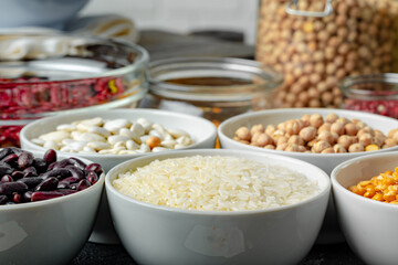 White ceramic bowls with assorted grains on kitchen table