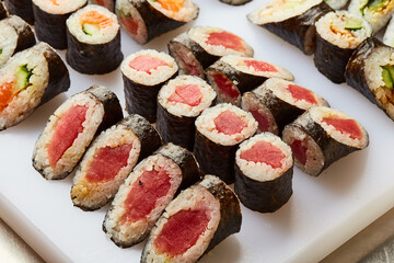 Various kinds of sushi roll set served on cutting board. Japanese food