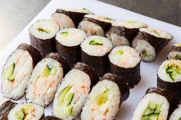Various kinds of sushi roll set served on cutting board. Japanese food