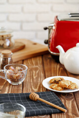 Ceramic teapot and toaster, kitchen table close up