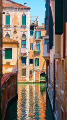 Fototapeta na wymiar Old houses by canal in Venice