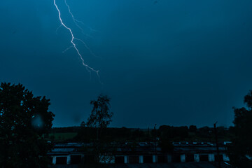 Stormy weather. Bright lightning across the dark sky.