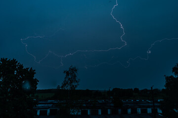 Stormy weather. Bright lightning across the dark sky.