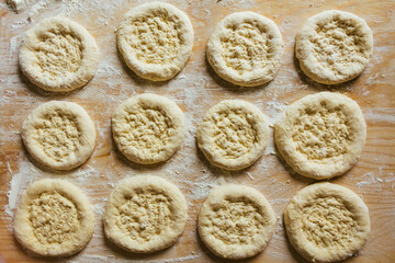 Cooking at home, rows of flatbreads ready to be baked