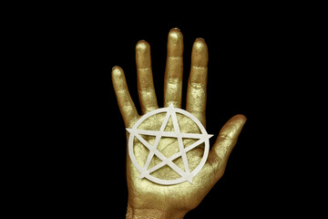 New age modern magic, occult symbol for your ritual. Pentagram in open golden palm on black...