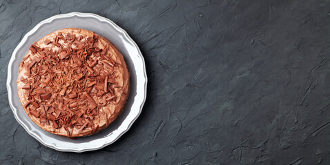 Chocolate cake on a plate and black rustic table background