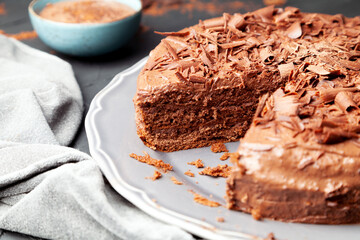 Sliced ​​chocolate cake on a plate with a tablecloth and chocolate mousse