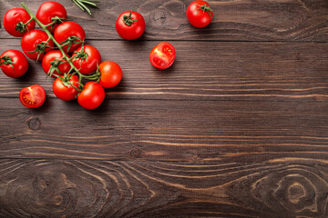 Red ripe cherry tomatoes on wooden table