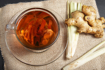 Picture of traditional herbal drink that contains ginger, clove, limegrass, cinnamons and secang (Caesalpinia sappan L) for immunity improvement