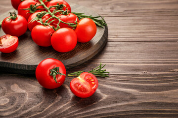 Red ripe cherry tomatoes on wooden table