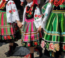 Girls in traditional folklore costume druring Corpus Christi procession in Lowicz, Poland