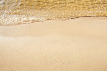 Fototapeta na wymiar Sandy beach and wave of sea