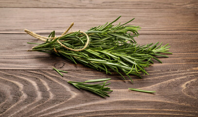 Fresh rosemary sprigs on rustic kitchen table