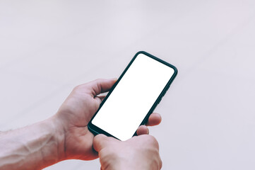 Mock-up technology. Man holds a smartphone in his hands close-up.