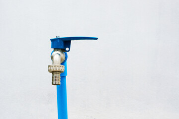 Outdoor faucet is Installed near the wall and made from brass
