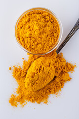 natural turmeric powder on white acrylic background